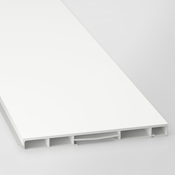 A close-up of a modern white cabinet plinth, showing sleek surface and support brackets.