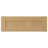 A FORSBACKA drawer front in warm oak wood. Its classic frame design beveled edges.