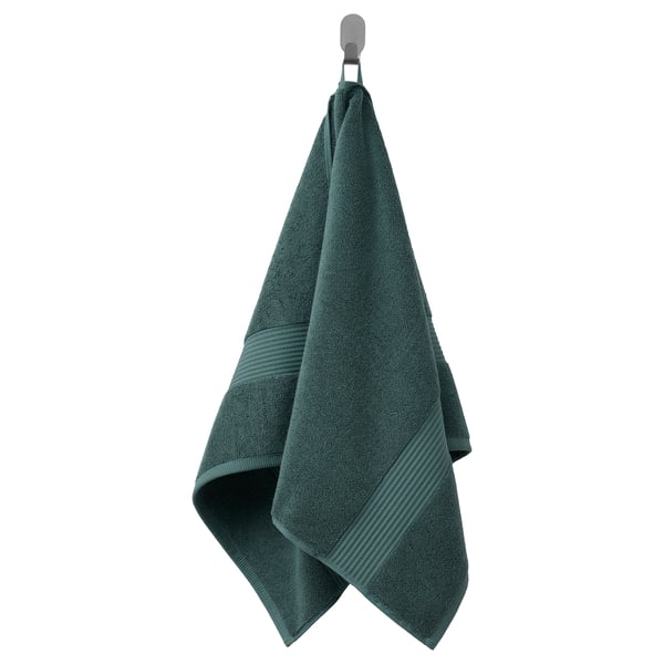 A dark green, thick FREDRIKSJÖN towel hanging, made of 100% cotton with a decorative woven border.