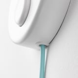 White lamp with turquoise cord, securely attached to wall. Quality design, safety tested.