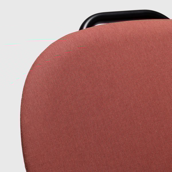 Red upholstered office chair backrest with black handle, showcasing modern design and sturdy fabric.