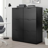 Black GALANT storage unit with 6 drawers, next to a grey chair and plant, offering closed storage.