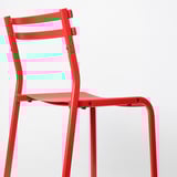 Bright red durable metal chair with sleek design, sturdy legs, and comfortable seat, ideal for lasting use.