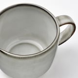 Sleek, stoneware jug with speckled gray glaze, sturdy handle for comfortable grip.