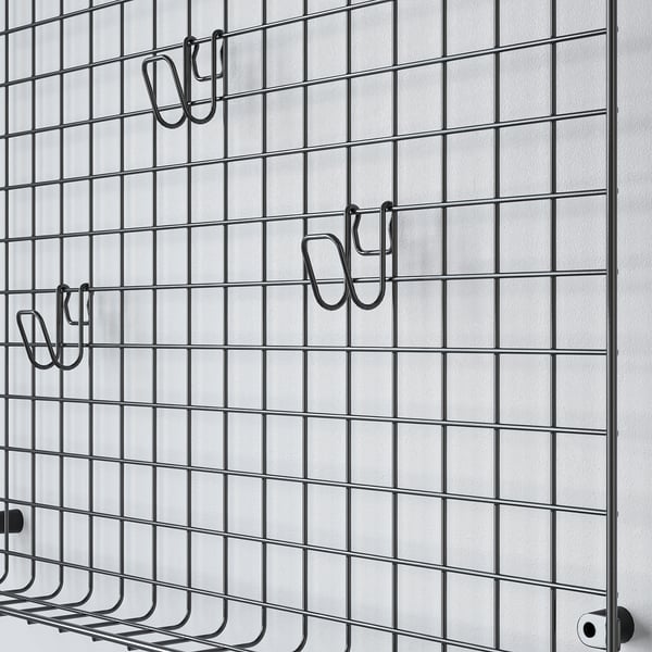 Black wire mesh storage grid with three hooks, ideal for organising items.