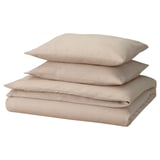 A GROVSNÄRJA bedding set in beige, featuring soft cotton flannel materials with a smooth and warm texture, including a duvet cover and pillowcases.