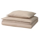 A neatly folded beige GROVSNÄRJA duvet cover and pillowcase set made from soft, brushed cotton flannel, perfect for cozy nights.