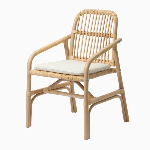 A rattan chair with a cushioned seat, offering comfort and easy cleaning with a washable cover.