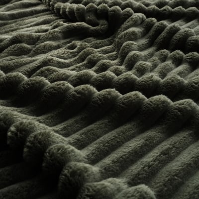 Dark green folded blanket with textured stripes and scalloped edge.