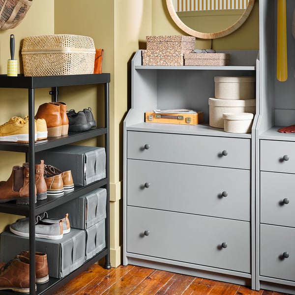 A gray HAUGA chest of drawers with 3 drawers and a top shelf. Its stylish for home storage.