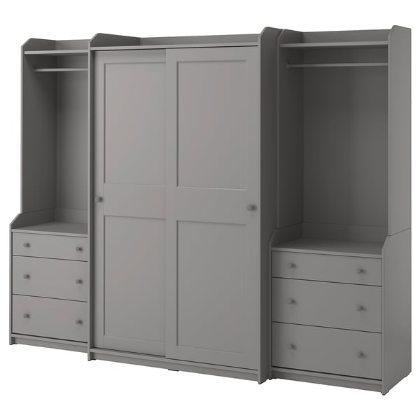 Gray HAUGA wardrobe system with sliding doors, shelves, and drawers for storage.