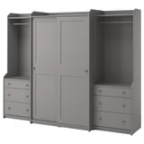 Gray HAUGA wardrobe system with sliding doors, shelves, and drawers for storage.