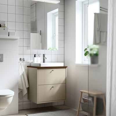 Bathroom with HAVBÄCK beige vanity, semi-recessed sink, two drawers, and mirror.