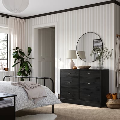 A dark grey HAVSTA chest of drawers with six large drawers. Crafted from solid pine, it boasts a sleek, modern design ideal for bedrooms.