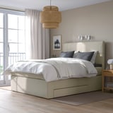 HEMFJÄLLET beige divan bed with 2 storage drawers, soft headboard, white/grey bedding, large pendant light, window, balcony.