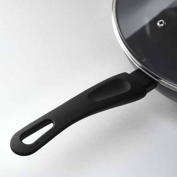 Black wok handle with glass lid; sturdy, non-slip design.