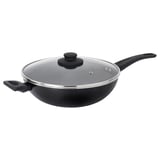 The HEMLAGAD wok in black with glass lid and two handles is ready for stir-frying.