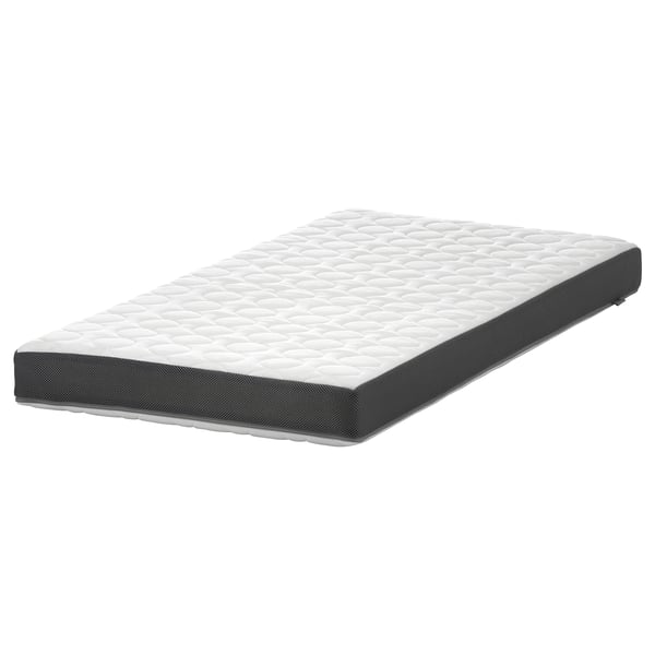 Grey rectangular kids mattress with quilted white top, washable cover.