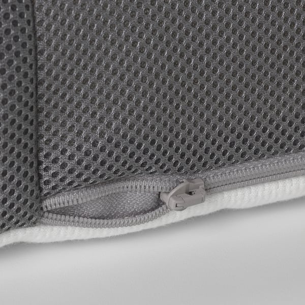 Close-up of a zipper on a grey mesh mattress cover. Quality zipper pull, sturdy stitching, and functional design.