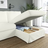 A modern white sofa with a lift-up chaise longue revealing board games and blankets in storage.