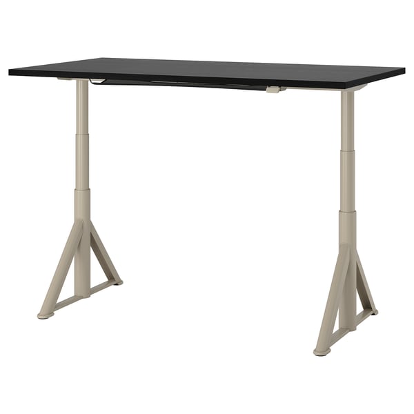 An IDÅSEN desk, rectangular with a black top and beige legs. Its adjustable, sturdy, and has a cable management solution.