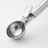 Stainless steel ice cream scoop with trigger mechanism for quick, mess-free serving. Easy-grip handle with loop for hanging.