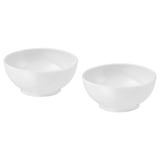 Two white porcelain bowls by ikea; simple, round shape; stackable design.