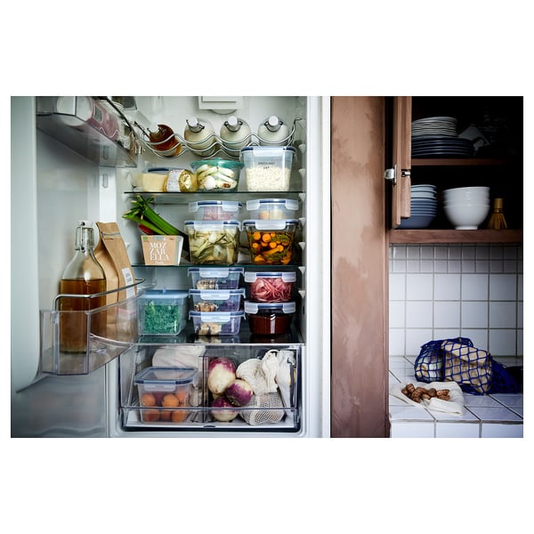 Neatly organized fridge and kitchen counter with various food items and containers.
