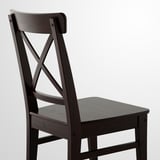 Dark wood chair with curved backrest and slatted seat, showcasing solid craftsmanship.