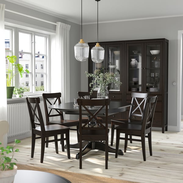 Modern dining room with INGATORP table, chairs, hanging lamps, extendable table, dark sideboard, large windows with curtains.