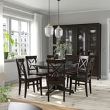 Modern dining room with INGATORP table, chairs, hanging lamps, extendable table, dark sideboard, large windows with curtains.