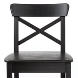 Black wooden chair with x backrest, sturdy, elegant design. Solid pine construction, high-quality finish.
