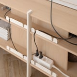 JÄTTESTA wooden shelf unit with white cable holder, organizing cords neatly.