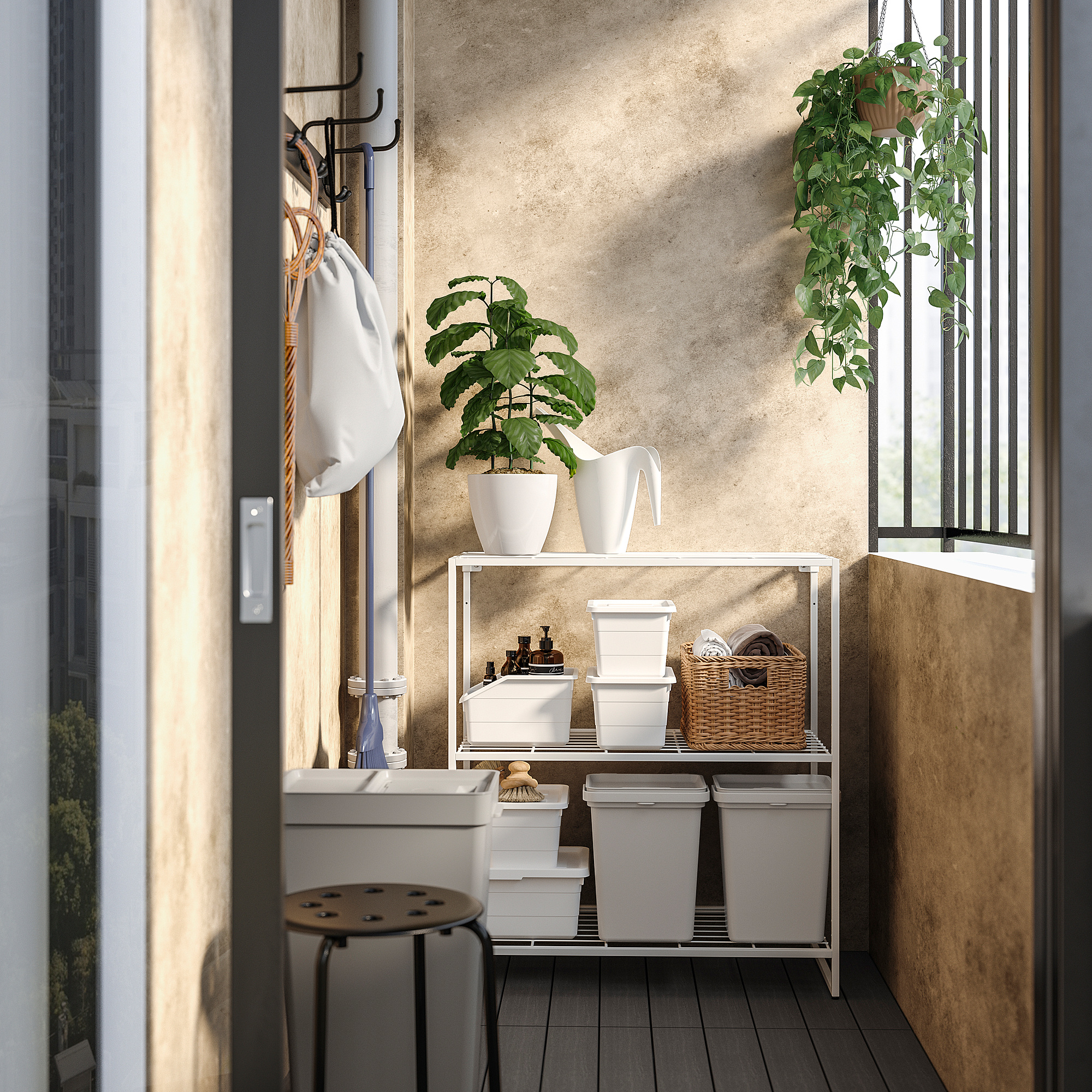 Small, organized laundry room with white JOSTEIN storage shelves against a wall, holding baskets and plants.