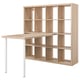 A light wood KALLAX shelving unit with a built-in desk, featuring multiple open cubes for storage.