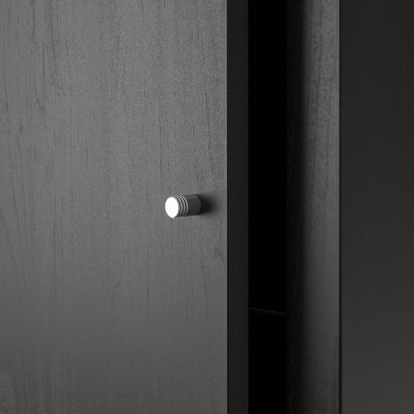 A dark gray KALLAX shelf unit, sleek and modern. Stylish knobs for drawers, set against a smooth, finished surface.