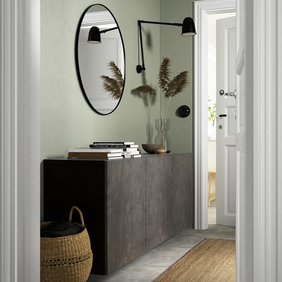 Well-organized entry with KALLVIKEN dark grey cabinet, wicker basket below. Mirror above, decor on top, leading to bright hallway.