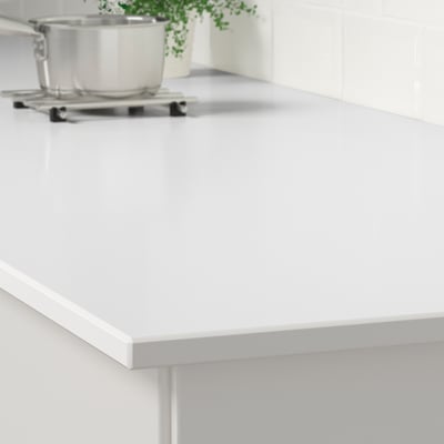 White quartz countertop displaying smooth, stain-resistant surface with sleek edge and modern kitchen setup.