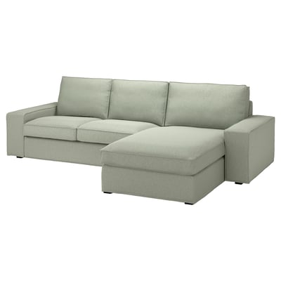 KIVIK sofa in light green, rectangular with chaise, low armrests, fabric cover, comfortable seating.