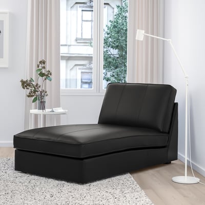 Black KIVIK leather chaise in modern living room by large window.