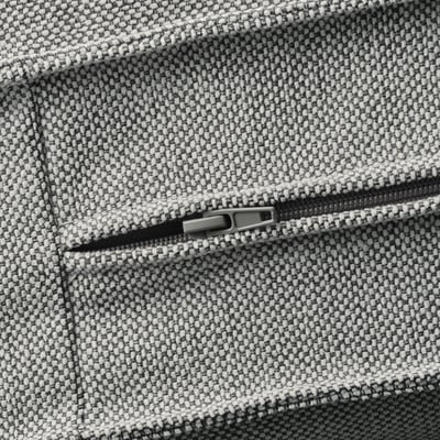Close-up of a zipper on a textured, tweed-like sofa cover, highlighting its high-quality fabric and durable design.