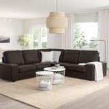 Black KIVIK sofa, light, tables, lamp, bright living room.