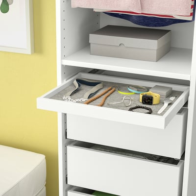White wardrobe with pull-out tray showing jewelry organizer containing watches, bracelets, and other accessories.