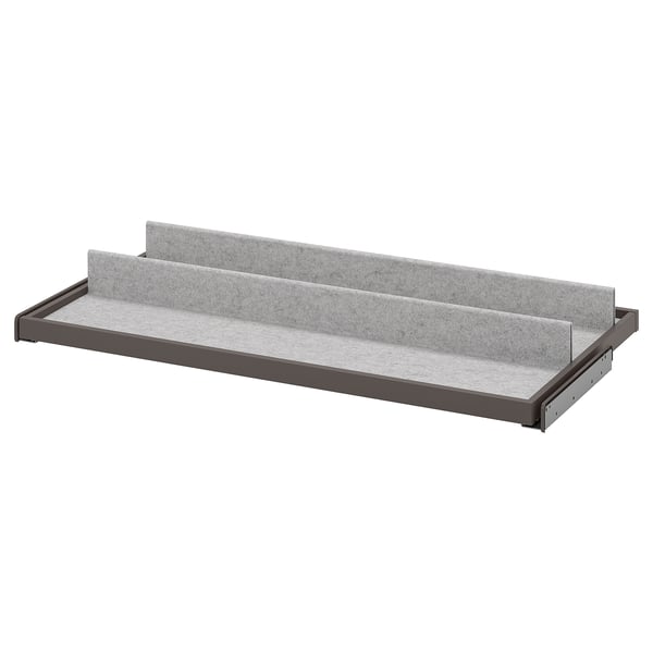 A gray KOMPLEMENT pull-out tray with felt lining for organizing items in a wardrobe.