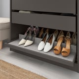 Shoe storage shelf with felt lining for displaying and protecting footwear.