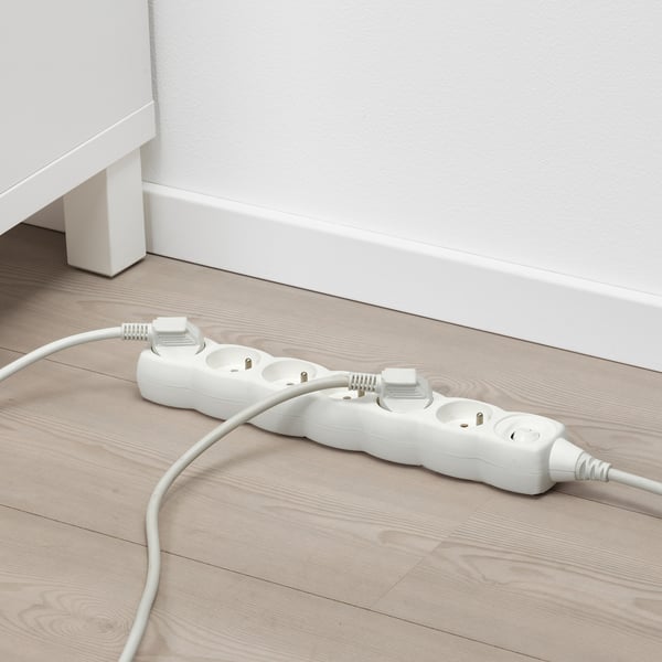 White surge protector with 6 sockets and switch on floor.