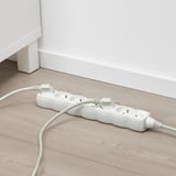 White surge protector with 6 sockets and switch on floor.