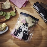 Two cats KUSTFYR bags: one holds sandwich, other cucumber slices. Pe plastic.