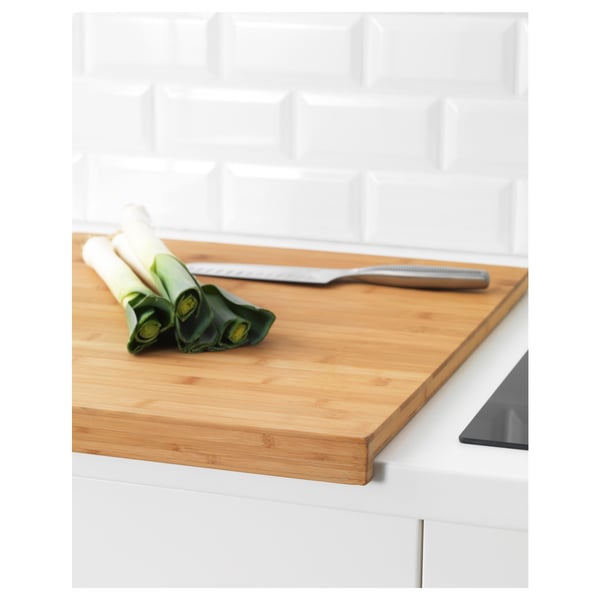 Wooden kitchen cutting board with groove to catch juices, prevents spills on the countertop.