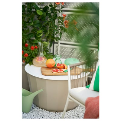 Modern white outdoor coffee table with ribbed design and removable tray top.